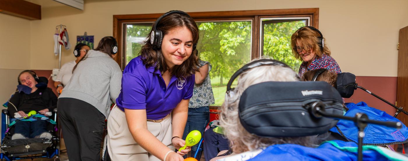 Kaylie Glenn engaging with Happy Headphones participants at the Heinzerling Community